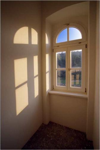 an empty room with two windows in a house at Villa Reder in Bad Sauerbrunn