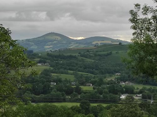 a view of a valley with hills and trees at Gîte des 3 arbres in Aramits