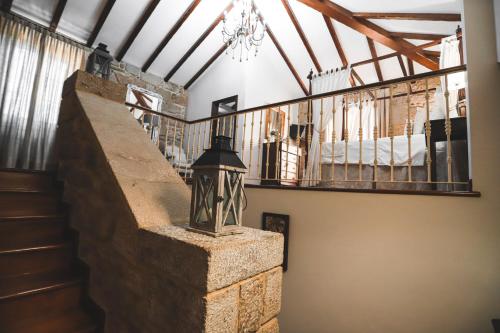 a staircase in a building with a chandelier at Torre do Rio in Caldas de Reis