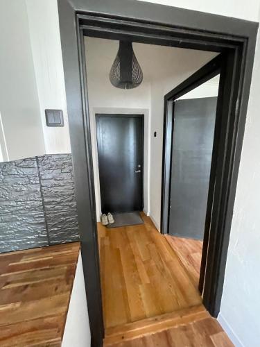 a hallway with a mirror and a wooden floor at Nice apartment in Maardu in Maardu