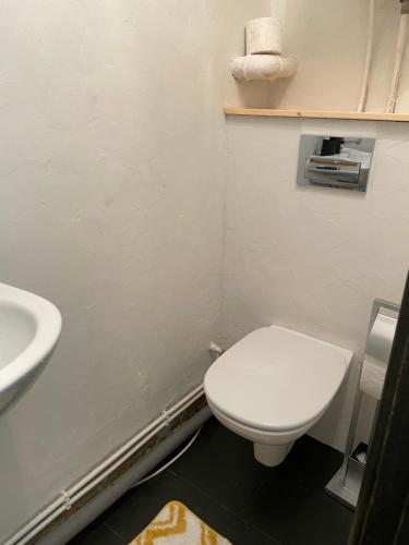 a bathroom with a white toilet and a sink at Nice apartment in Maardu in Maardu