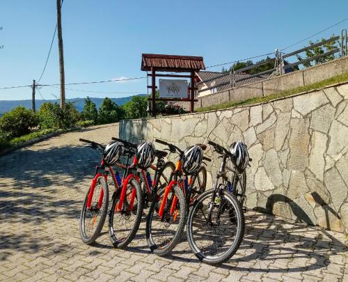 a group of bikes parked next to a stone wall at Apartment Valy - big terrace & free bikes in Bled