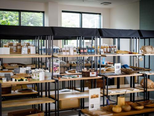 a display case in a bakery with lots of food at Denpaku Akakina Hotel in Amami