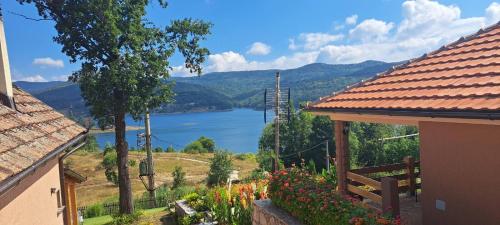 a view of a lake from a house with flowers at Vila Vera Borsko Jezero in Bor