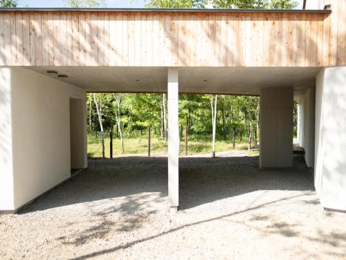 an empty building with a wooden roof at Coboushi オモヤ in Niseko