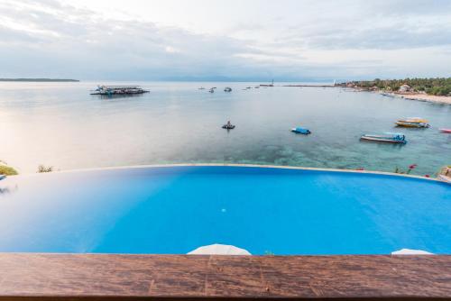 a view of a body of water with boats in it at Sea La Vie Resort Nusa Penida in Nusa Penida