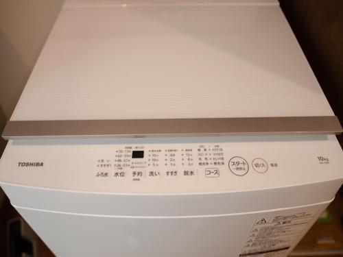a white stove top oven with a silver top at Coboushi ハナレ in Niseko