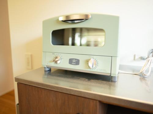 a toaster oven sitting on top of a counter at Coboushi ハナレ in Niseko