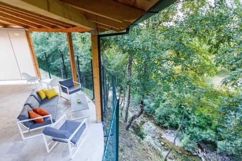 an overhead view of a porch with a couch and chairs at Family SPA Apartments Sunny&Shiny in Šavnik