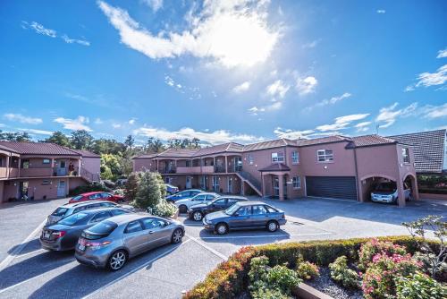 a group of cars parked in a parking lot at Kings Of Riccarton Motel- Close to Railway Station and Airport with Shuttle service in Christchurch