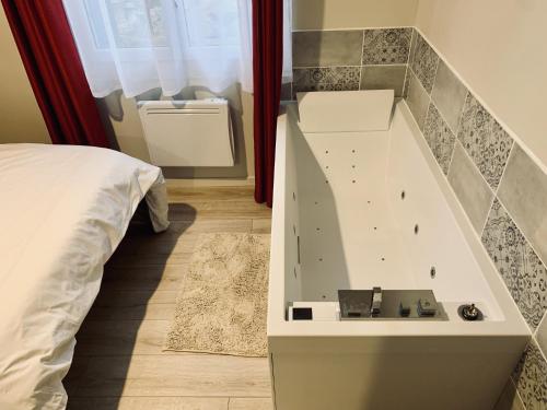 a bedroom with a bed and a wall with a rock wall at Gignac - Superbe cocon indépendant avec balnéo et jardin in Gignac