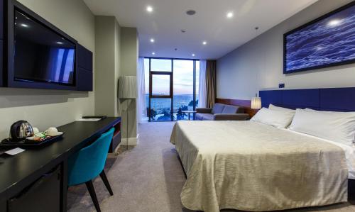 a hotel room with a bed and a television at Marvie Hotel & Health in Split