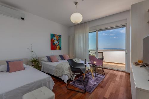 a bedroom with two beds and a view of the ocean at Terra Magica Deluxe Apartment Or Room with Private Parking, Terrace and Sea View in Rijeka
