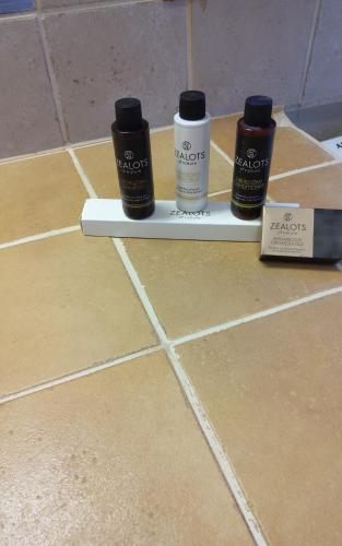 three bottles of paint sitting on a shelf on a tile floor at Harmony Seaview Villas In Elafonisos in Elafonisos