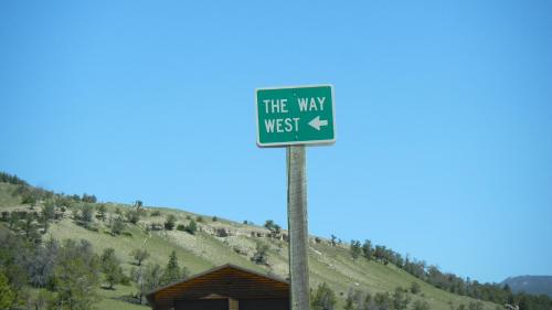 a blue sign that says the way to the way at Super 8 by Wyndham Cody in Cody
