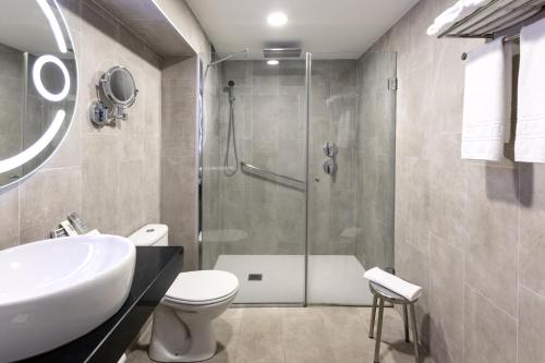 a bathroom with a shower and a toilet and a sink at Catalonia Punta del Rey in Candelaria