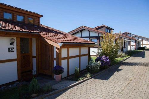 a row of houses on a brick road at Feriendorf Öfingen 08 in Bad Dürrheim