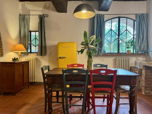 a dining room with a wooden table and chairs at Le Fonti di San Gimignano in San Gimignano