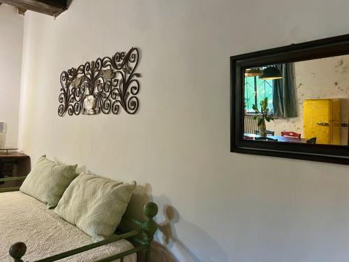 a bedroom with a mirror and a bed at Le Fonti di San Gimignano in San Gimignano