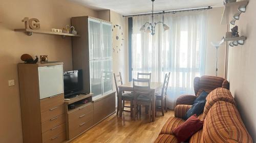 a living room with a couch and a table at El Primero G Zaragoza - Aljafería in Zaragoza