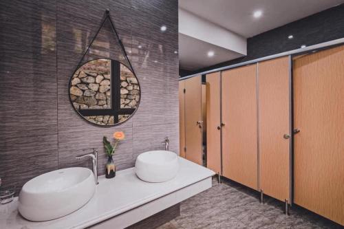 Baño con 2 lavabos y espejo en Villa de Montana, en Ba Vì