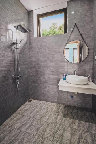 a bathroom with a sink and a mirror at Villa de Montana in Ba Vì