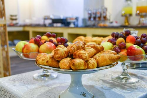 two plates of pastries and fruit on a table at Hotel Randy in Constanţa