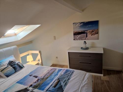 a bedroom with a bed and a dresser and a window at Melroce Holiday Cottage 5503 in Bredene