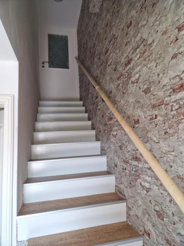 a staircase in a house with a brick wall at Friesenparadies FRI-Südliches Friesland in Bockhorn