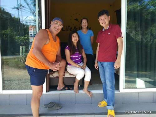 a group of people standing outside of a house at Life&Love Resort in Ban Khlong Son