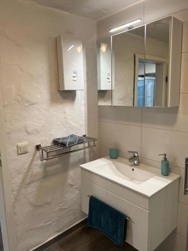 a bathroom with a white sink and a mirror at Gemütliches Appartement in Lohmar-Wahlscheid in Lohmar