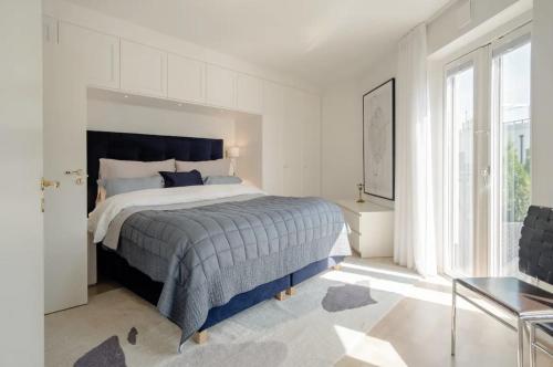 a bedroom with a bed and a large window at Stadsporten Nacka in Nacka