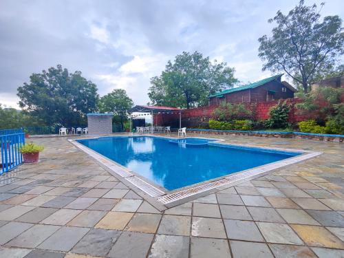 - une piscine d'eau bleue dans la cour dans l'établissement Hill View Resort by Rudrakshi, à Udaipur