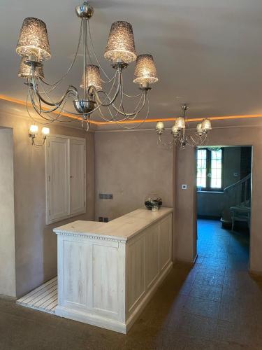 a kitchen with two chandeliers and a kitchen island at Willa pod Seidorfem in Sosnówka