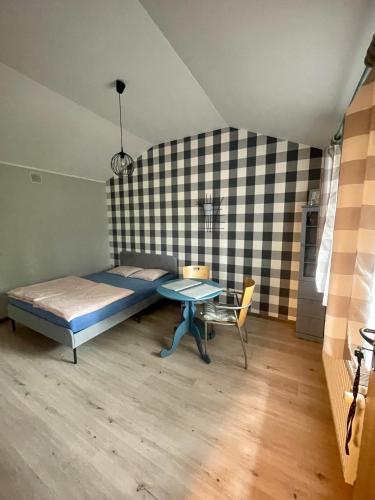 a bedroom with a bed and a table in it at Uniejów PORT pod Sosnami in Uniejow