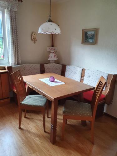 a dining room table with chairs and a couch at Ferienhaus Waldglück in Gosau