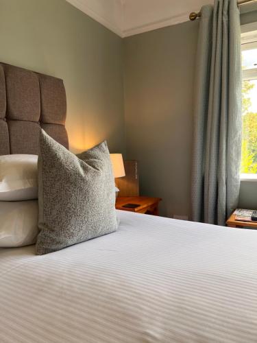 a bedroom with a bed with a pillow on it at Devonshire Arms Inn in Cracoe