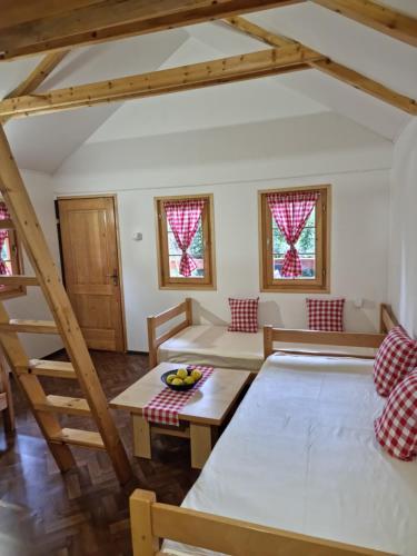 a living room with a bed and a table at Holiday Home SAJRA in Kulen Vakuf