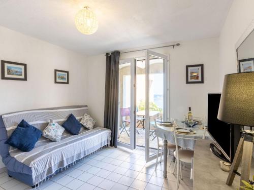a living room with a couch and a table at Apartment Les Roches Bleues-1 by Interhome in Collioure