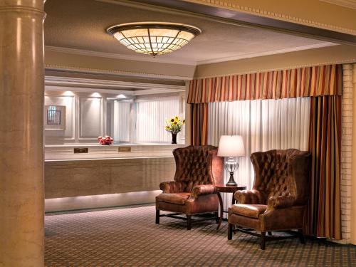 two chairs and a lamp in a hotel room at Royal Scot Hotel & Suites in Victoria