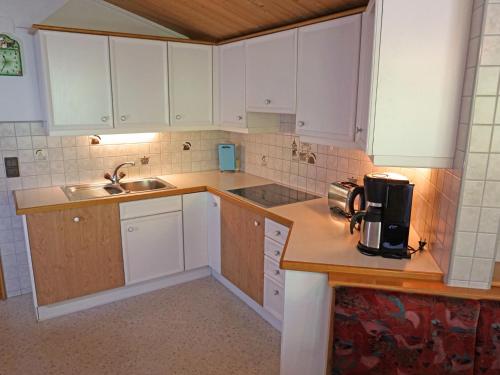 a kitchen with white cabinets and a sink at Apartment Erika by Interhome in Kappl