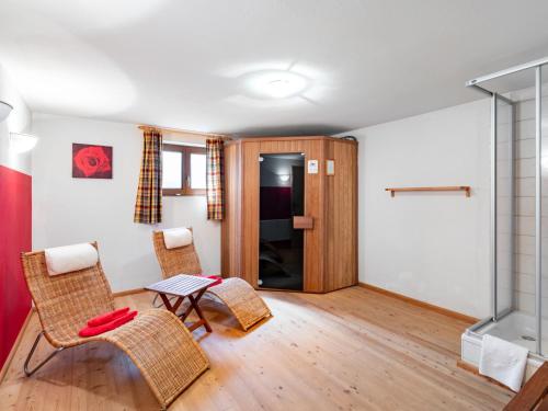 a living room with chairs and a table at Holiday Home Haus am Sonnenhang by Interhome in Spielbichl