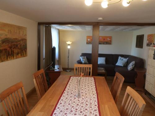 a dining room with a table and a couch at Holiday Home Roth by Interhome in Neuried