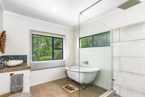 a bathroom with a shower and a tub and a sink at Rhino Retreat Clarens in Clarens