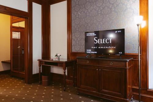 a hotel room with a flat screen tv on a dresser at Hotel Select in Iaşi