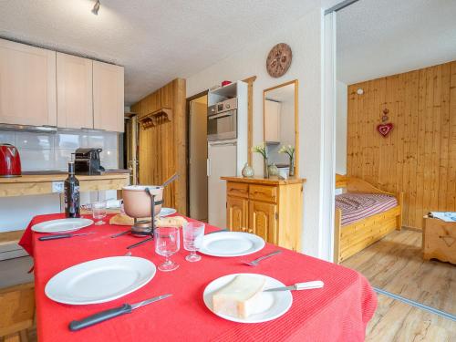 a kitchen with a table with a red table cloth at Apartment Arcelle-22 by Interhome in Val Thorens