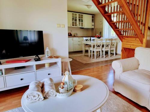 a living room with a table and a living room with a tv at Holiday Home Holiday Hill 42 by Interhome in Lauterwasser