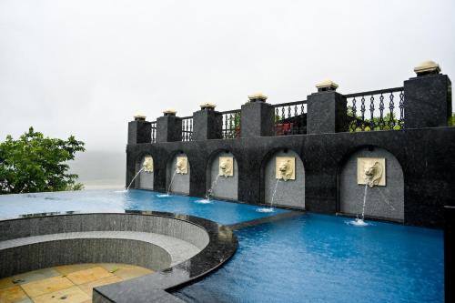 a swimming pool on top of a house at The Green Gate Resort Mulshi in Pune