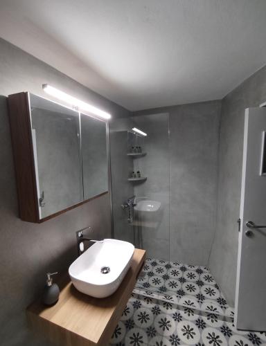a bathroom with a sink and a shower at Rosolio in Ano Syros
