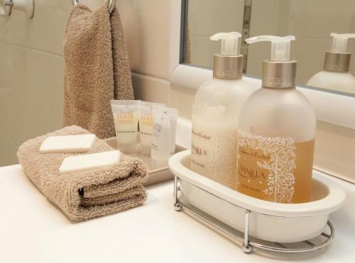 a bathroom with two bottles of soap and towels at Chinchilla White Gums Motor Inn in Chinchilla